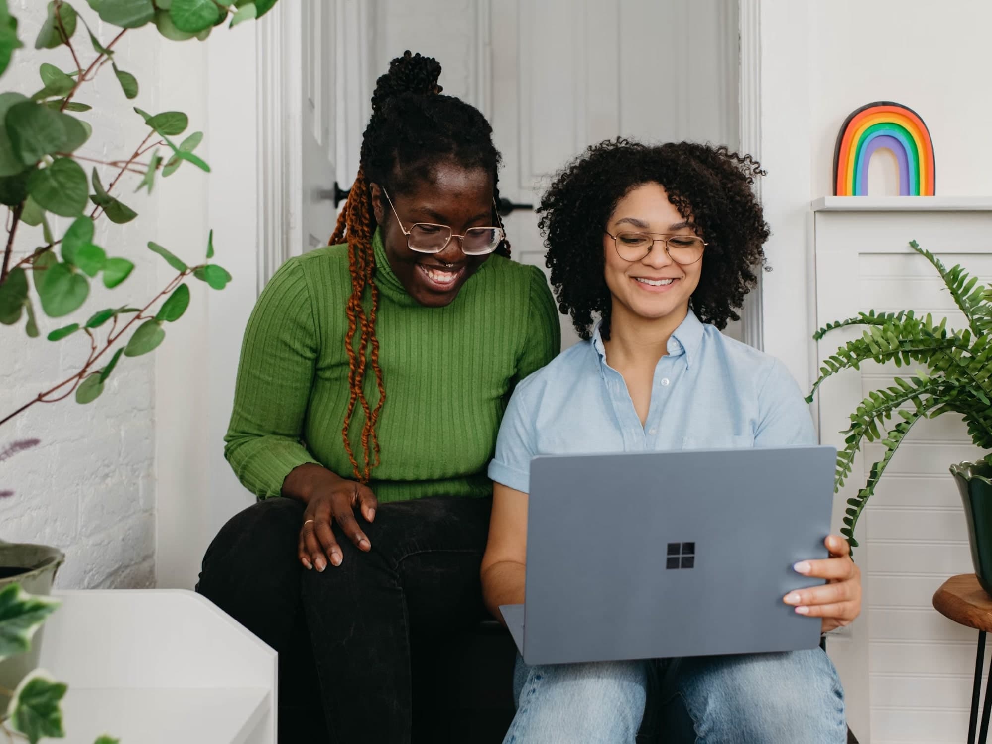 Two colleagues reviewing a design on a laptop