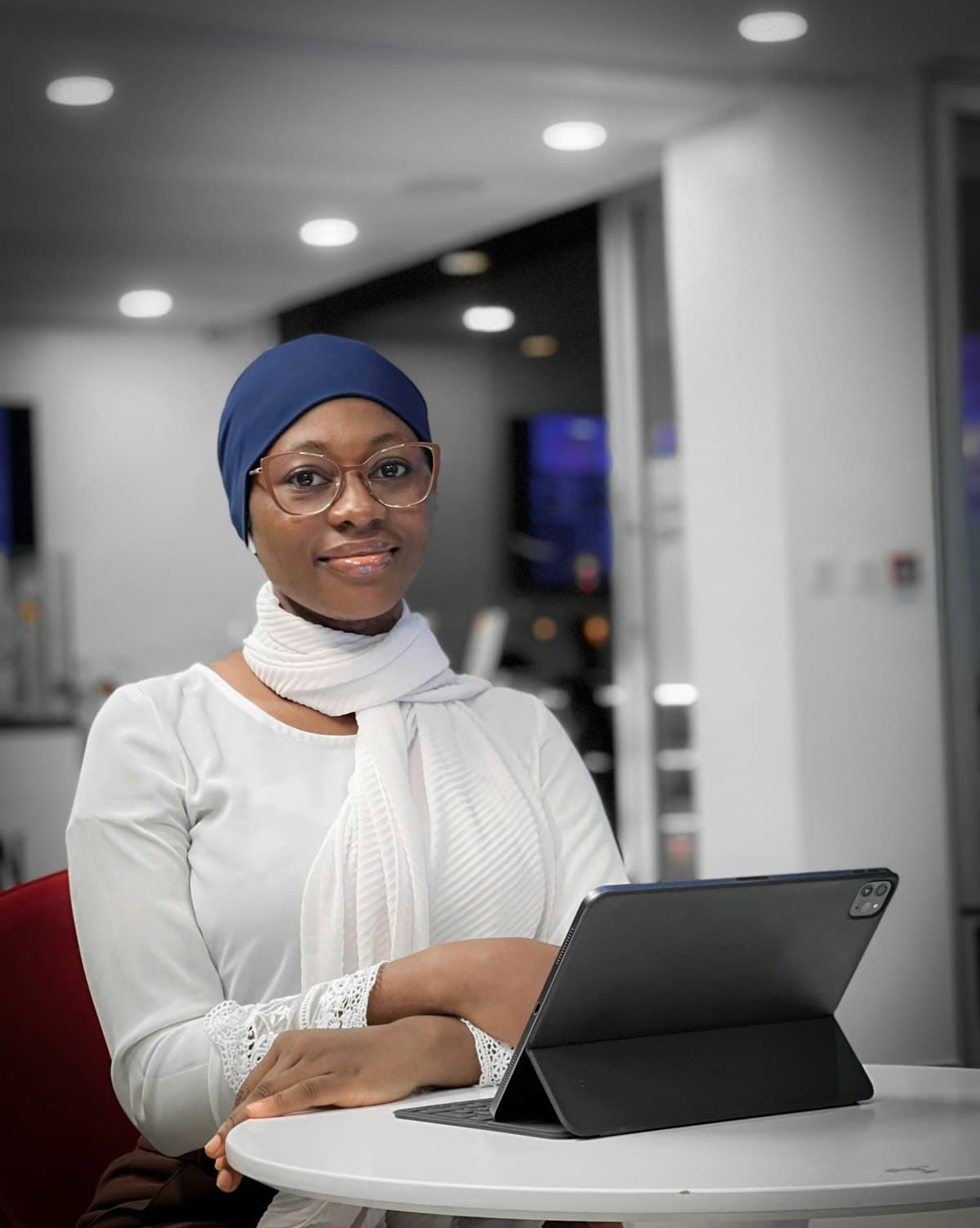 A professional at a tablet in a modern Lagos office